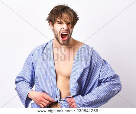 Sexy Macho With Angry Face Stands In Bathrobe. Morning Concept. Man With Beard In Blue Dressing Gown