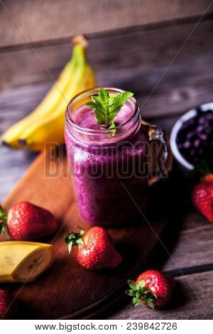 Blueberry Smoothies On A Wooden Background With Fruits. Vitamins A