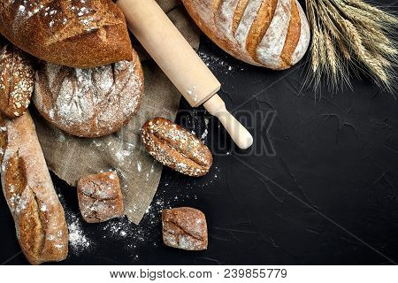 Bakery - Gold Rustic Crusty Loaves Of Bread And Buns On Black Chalkboard Background. Still Life Capt