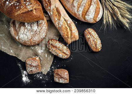Bakery - Gold Rustic Crusty Loaves Of Bread And Buns On Black Chalkboard Background. Still Life Capt