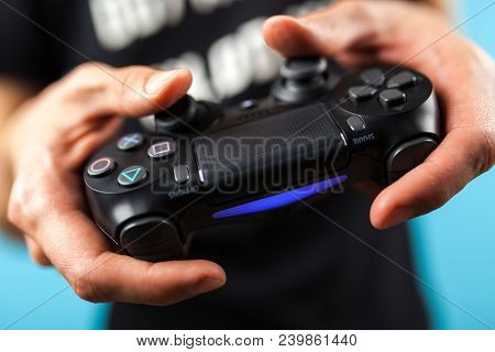 Male hands holding a PS4 controller
