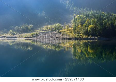 Autumn Season Theme. Detail Of Coloured Forest. Sun Beam Shines On Trees. Plansee, Tyrol, Austria.