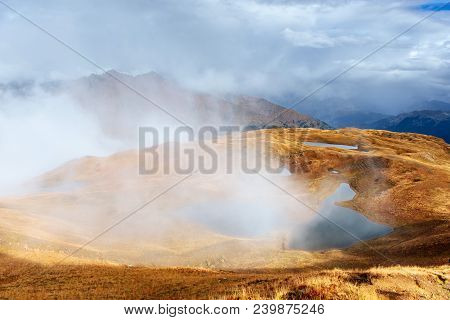 Majestic Mountain Landscape. Koruldi Lakes And A Tourist Admiring The View. Active Life Concept.