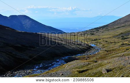 Chugach National Forest Above Anchorage, Alaska.  Landscape
Of Mountains And Creek Running To The Oc