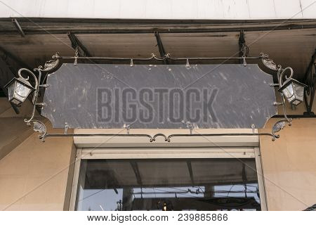 Close Up Of Vintage Template Shop Sign Mockup Outdoors. Iron-shod Blank Advertising Billboard With S