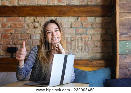 Happy Woman Showing Thumbs Up Near Laptop. Concept Of Seccussful Businesswoman And Modern Technology