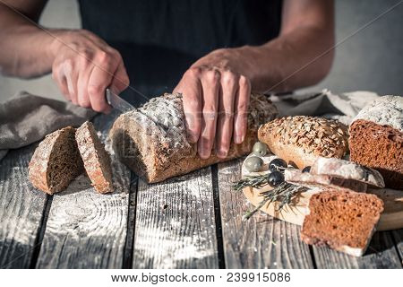 Baker Holding Fresh Bread In Hands