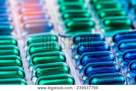 Selective Focus On Blue And Green Soft Gel Capsule Pills In Blister Pack. Naproxen And Ibuprofen (no