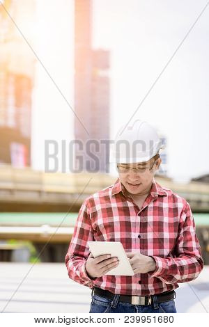 Asian Business And Engineer Man With Red Scott Shirt Has Planning And Working For Design Buiding And