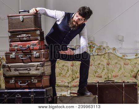 Man With Beard And Mustache Packed Luggage, White Interior Background. Move Out, Transportation Conc