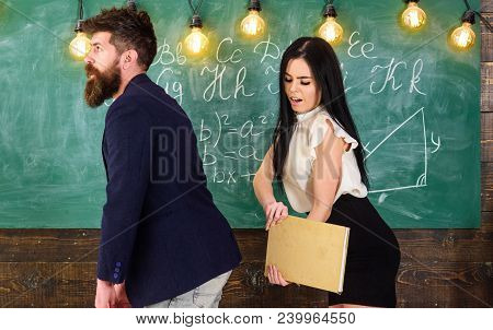 Student Lady Slapping On Teachers Buttocks With Book. Role Games Concept. Girl On Smiling Face Havin