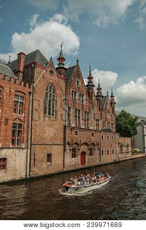 Bruges, Belgium - July 05, 2017. Boat And Brick Buildings On The Canal Edge At Bruges. With Many Can