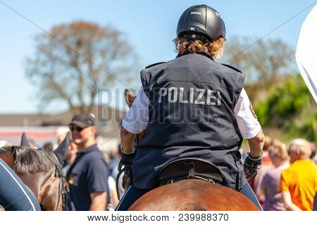 Delmenhorst / Germany - May 6, 2018: German Police Horsewoman Rides On A Police Horse For Training E