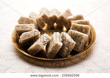 Fresh Nariyal Barfi / Coconut Burfi Or Khobra Vadi, Served In A Bowl Or Plate Over Decorative Backgr