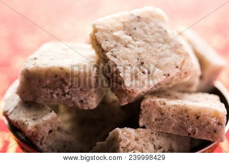 Fresh Nariyal Barfi / Coconut Burfi Or Khobra Vadi, Served In A Bowl Or Plate Over Decorative Backgr