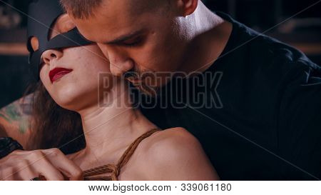 Shibari - A Man Tying Up A Woman In Cat Mask
