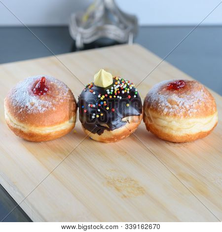 Close Up View Of Three Tasty Various Donuts On Wood Background. Hanukkah Celebration Concept. Round 