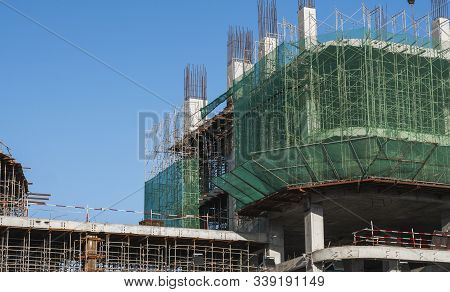 Building And Construction Site In Progress. Building Construction Site Against Blue Sky. Metal Const