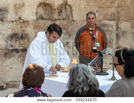 Ramla, Israel, December 07, 2019 : Priest Makes Communion At Collective Prayer On The Ruins Of A Byz