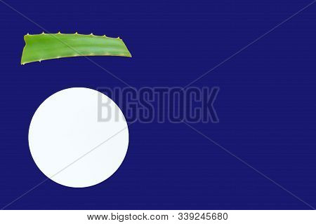 Aloe Vera Lef And White Cream Jar Of On A Deep Blue Background. Organic Cosmetics Concept. Top View,