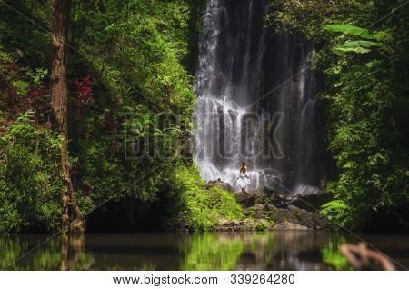 Woman near Labuhan Kebo Waterfall located in Munduk, Bali
