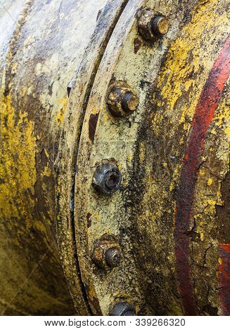 Bolt Coupling On The Old Metal Pipe (tube). Pipeline. Cracked And Damaged Yellow And Red Paint On Th