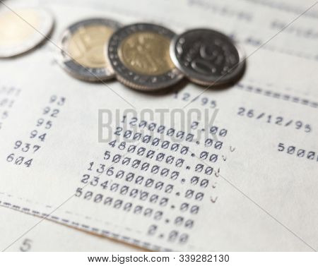 Typewritten Calculations And Coins. Bookkeeping (accounting). Economy. Financial Themes. Money Savin