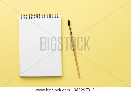 White Clean Notebook On Black Spring With Wooden Squirrel Brush On Bright Yellow Paper Background Wi