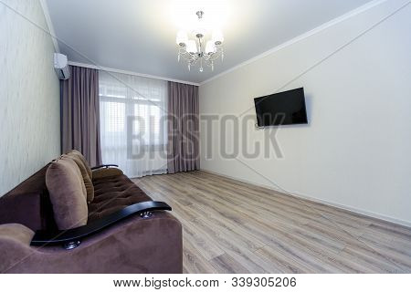 Apartment In A New Building. Room With A Sofa. Tv On The Wall