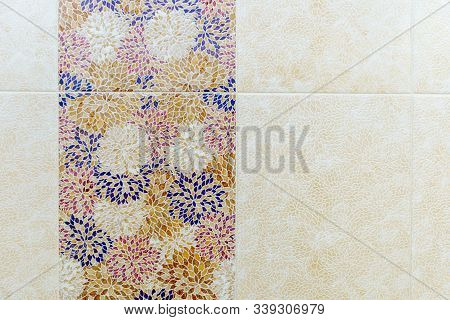 Square Ceramic Tiles In The Form Of Blue, Yellow, Red And White Leaf Patterns On The Wall In The Bat