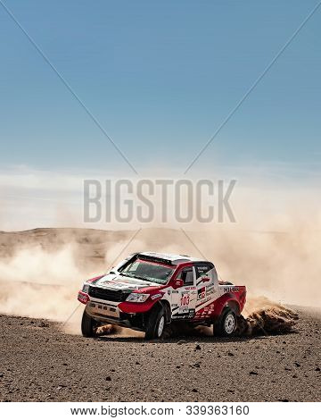 On Sand Dunes In Lut Desert With A Dakar Edition Race Car