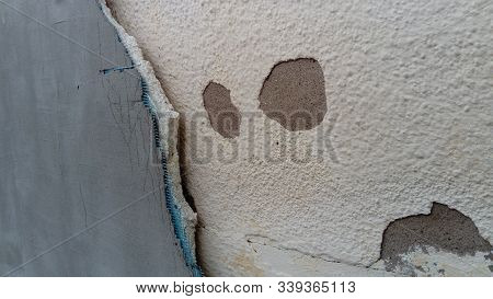 Crack On The Wall Of The House. Old Plaster Falls Off The Surface. Defect During Construction. The E