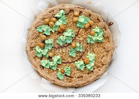 Whole Round Cake With Hazelnuts And Butter Cream Top View. Nut Cake In Packaging, Delicious Dessert 