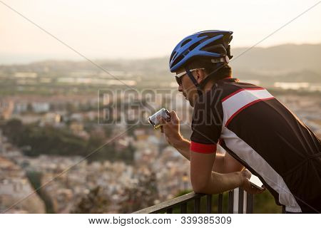 Adventure Male Vloger Using Action Camera Outdoor. A Male Cyclist Blogger Shoots Video On An Action 