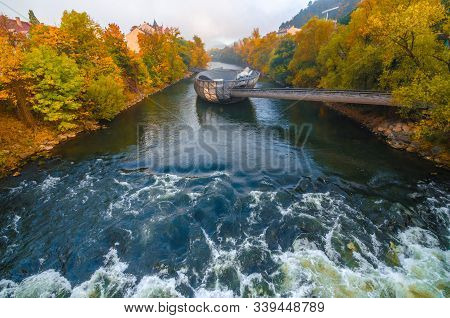Graz/austria-october 18, 2019: Mur River In Autumn, With Murinsel Bridge And Old Buildings In The Ci