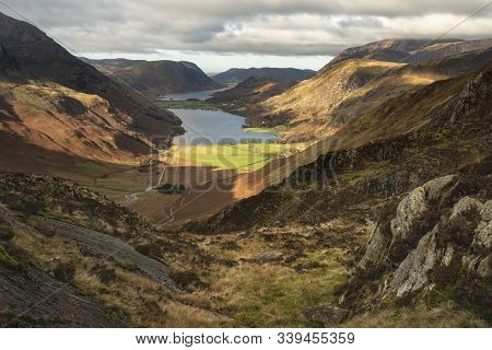 Epic Autumn Fall Landscape Of Buttermere And Crummock Water Surrounded By Mountain Peaks In Lake Dis