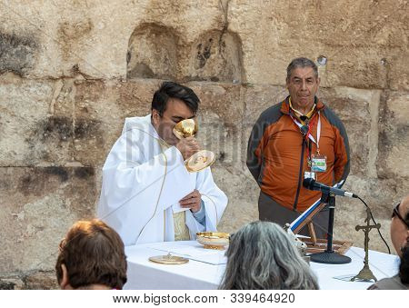 Ramla, Israel, December 07, 2019 : Priest Makes Communion At Collective Prayer On The Ruins Of A Byz