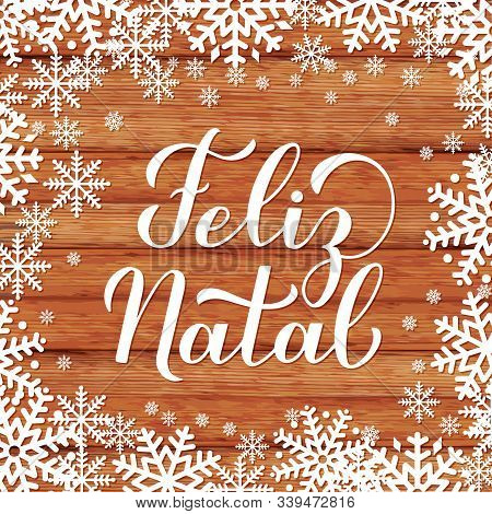 Feliz Natal Calligraphy Hand Lettering On On Wood Background With Snowflakes. Merry Christmas Typogr