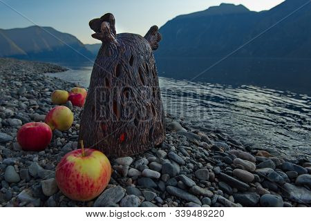 Mountain Altai, Russia. 09/15/2019. Clay God Surrounded By Apples Grown In Gardens On The Southern S