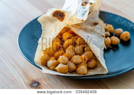 Tortilla Chickpea Wrap Samosa Buritto Ready To Eat With Natural Daylight On Wooden Table.