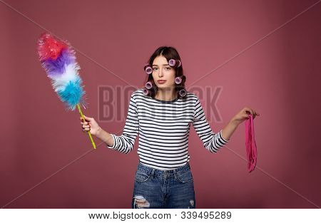 Sad Girl In Curlers With A Whisk For Dust.