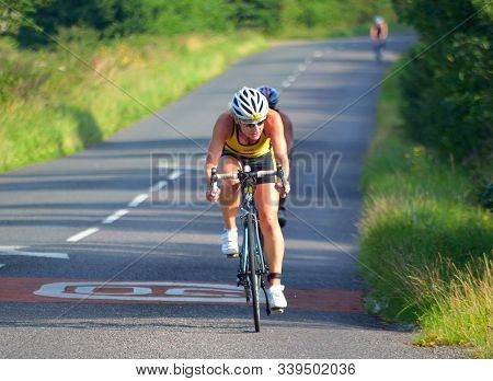 Grafham, Cambridgeshire, England - August 06, 2017:  Female Triathlete On Road Cycling Stage Of Tria