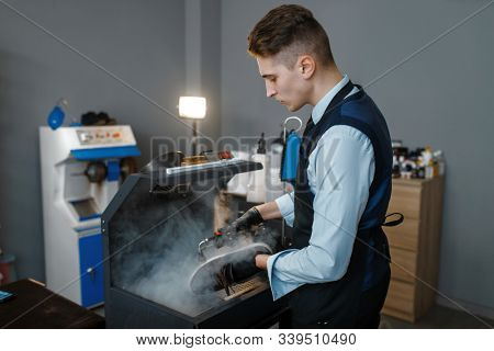 Bootmaker processes the shoes on special machine