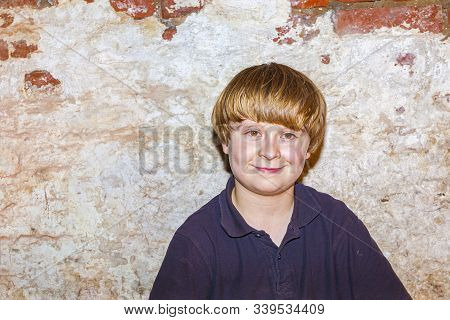 Cute Young Boy With Old Brick Wall Background