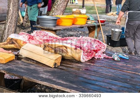 Butchers Slaughtering A Pig
