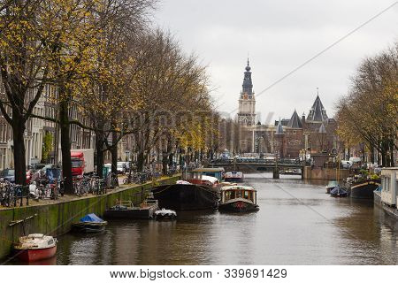 Amsterdam, Netherlands - November 28, 2019: Canal View Of The De Waag Weight House In Amsterdam City