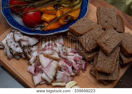 Bacon, Bread And Cucumber Over Wooden Background. Russian And Ukrainian Traditional Appetizer, Black