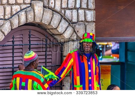 Montego Bay, Jamaica - March 20 2018: Jamaican Male Workers On The Job. Tall Mascots With Long Legs 