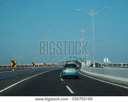 Denpasar, Indonesia - August 23, 2019: Vehicles Running On Bali Mandara Toll Road Which Carried By A