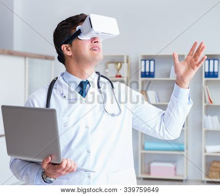 Young doctor with vr virtual reality headset working in the offi